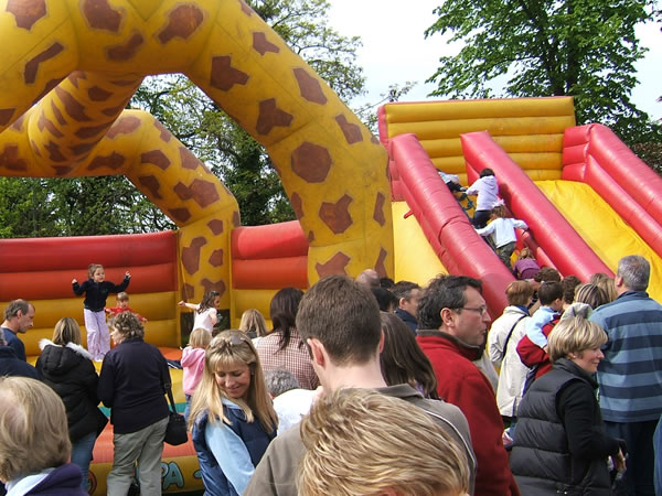 Fun for Children on Bouncy Inflatibles and Slide at Oatlands Village Fayre Weybridge Surrey